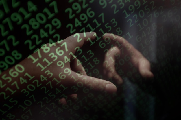 Mano recortada de una persona con código binario