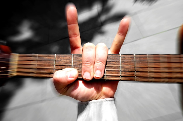 Foto mano recortada sosteniendo una guitarra al aire libre