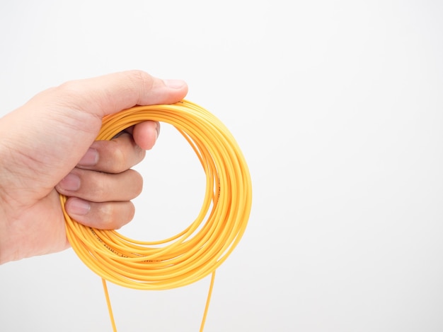 Mano sujetando el cable de conexión de fibra óptica de lazo blanco aislado