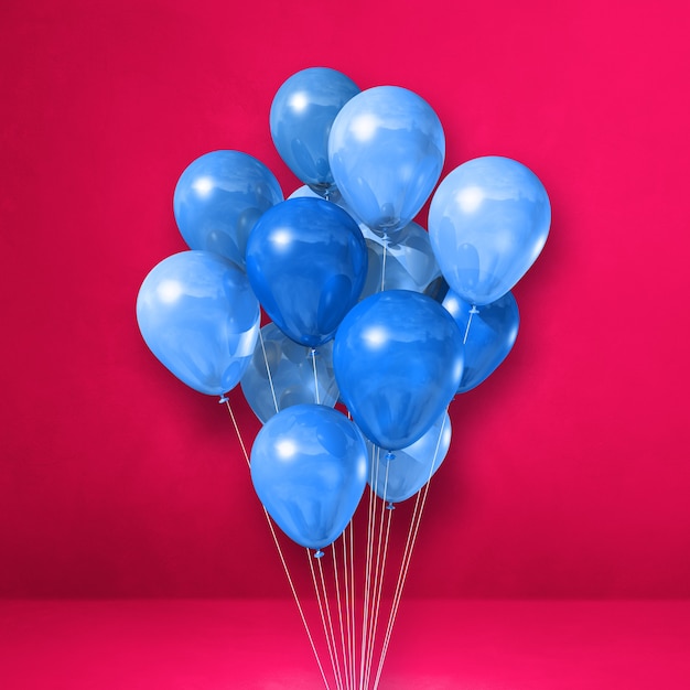 Manojo de globos azules en una pared rosa