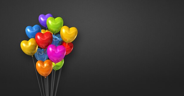 Manojo de globos de forma de corazón colorido sobre un fondo de pared negra. . Ilustración 3D render