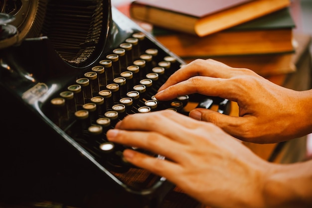 Manos cortadas de un hombre usando una máquina de escribir