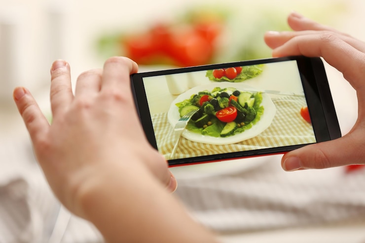 Foto manos femeninas fotografiando comida con teléfono móvil