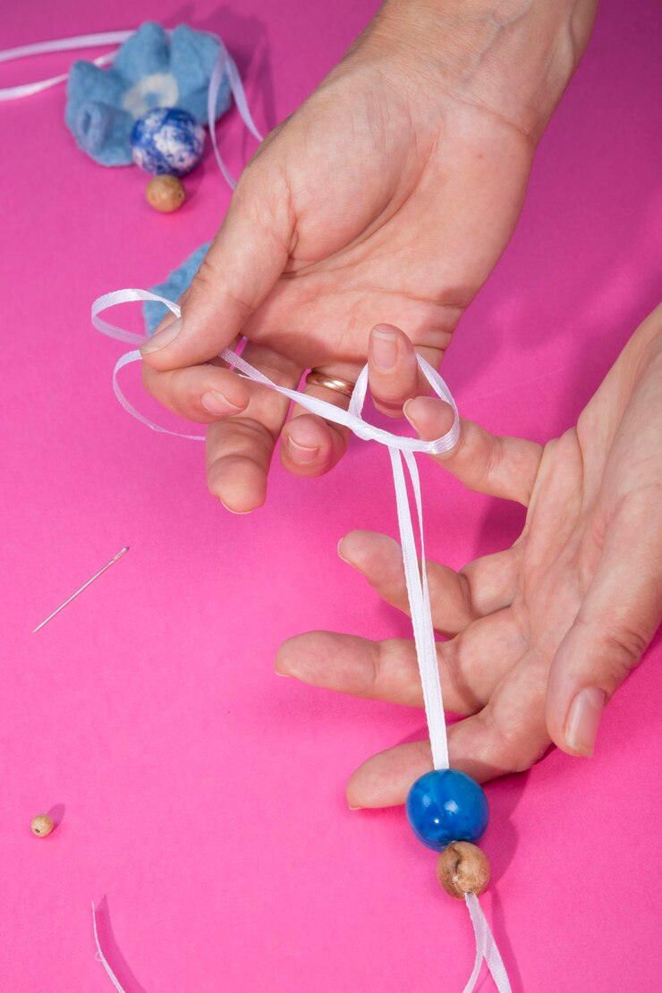 Foto las manos femeninas del maestro ensamblan un producto hecho a mano con lana afieltrada