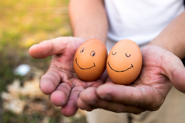 Las manos de un hombre para atrapar los huevos.