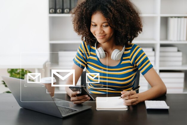 Las manos de la mujer africana usando una tableta portátil escribiendo en el teclado y navegando por Internet con el icono de correo electrónico concepto de marketing de correo electrónico enviar correo electrónico o boletín informativo en línea tecnología de red de Internet de trabajo