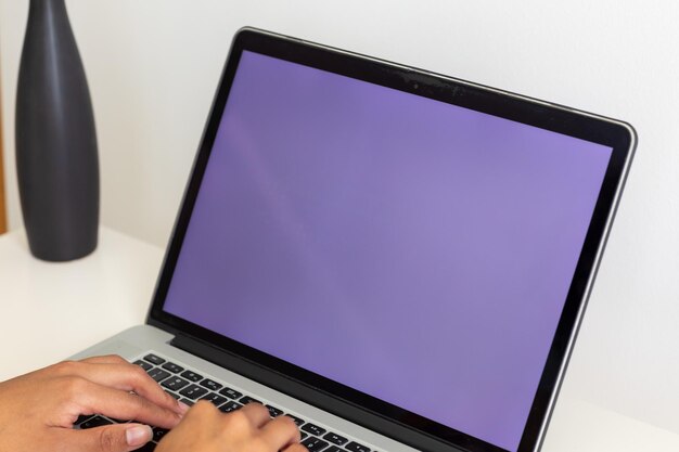 Las manos de una mujer biracial usando un portátil con espacio de copia en la pantalla en casa. Estilo de vida, comunicación y vida doméstica, inalterados.