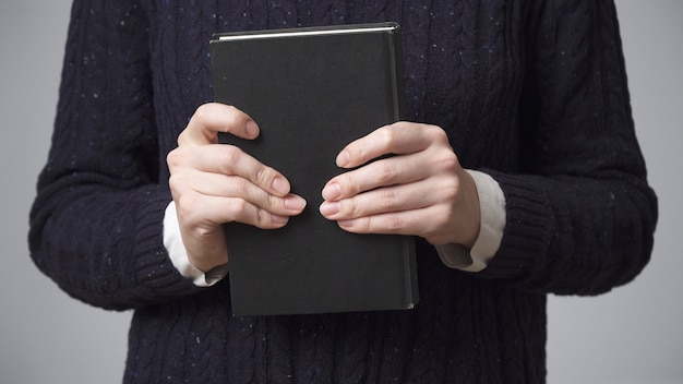 Manos de mujer sosteniendo un libro