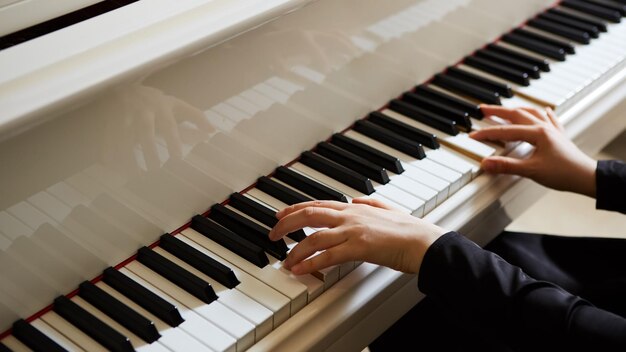 Manos de mujer en el teclado del piano closeup