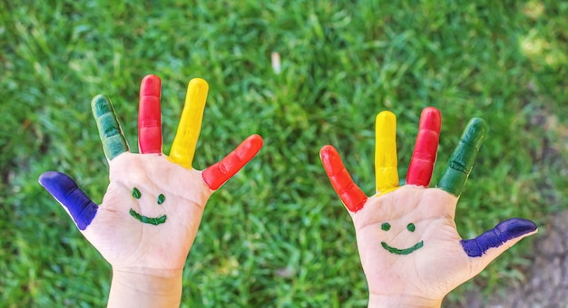 Foto manos de niños con los colores del verano. enfoque selectivo naturaleza