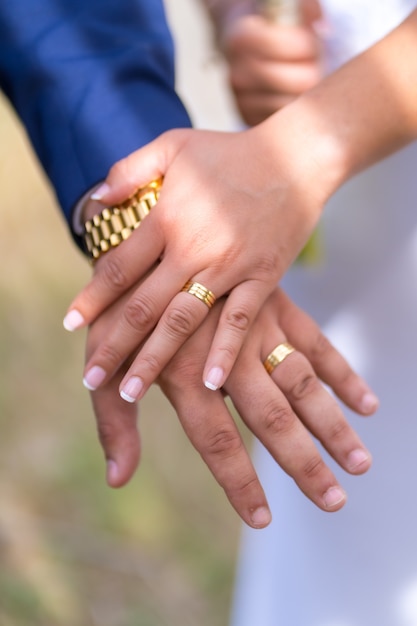 Manos del novio y la novia con los anillos de boda recién colocados en una celebración de boda