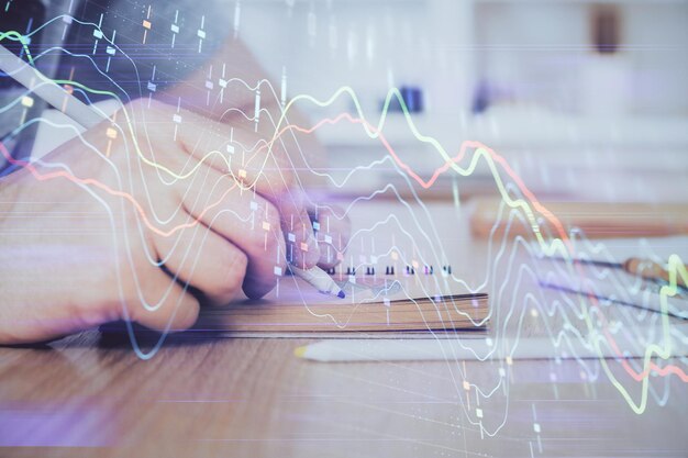 Manos de primer plano de exposición múltiple con gráfico de forex del mercado de valores