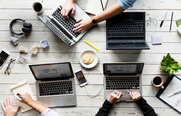 Manos que usan el trabajo en la computadora portátil en el área de trabajo de Office