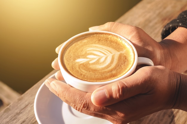 manos sosteniendo una taza de café