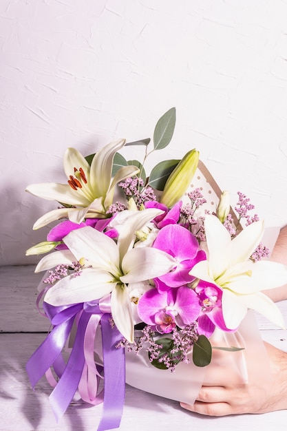 Mans Hände halten Blumenstrauß Eine schöne frische Blumen auf weißem Hintergrund