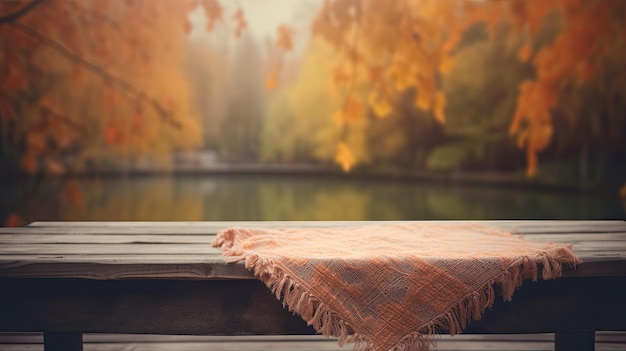 Una manta en un banco con hojas de otoño en el fondo.