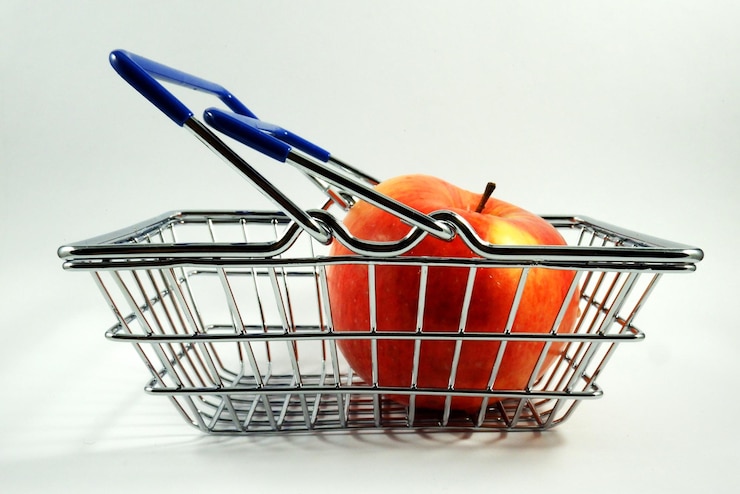 Foto manzana en la canasta de comestibles de cerca