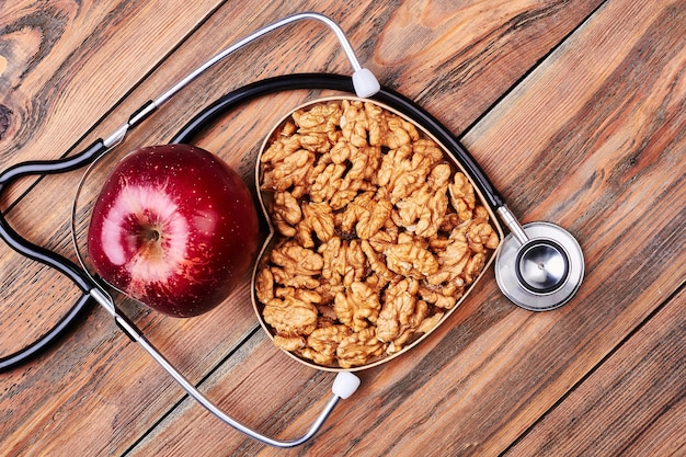 Manzana, nueces y estetoscopio. Publicidad del departamento médico.