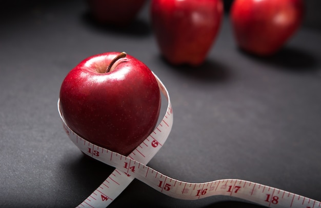 Manzana roja con cinta métrica