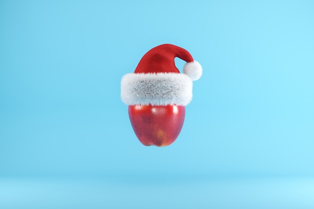 Manzana roja con gorro de Papá Noel flotando en azul