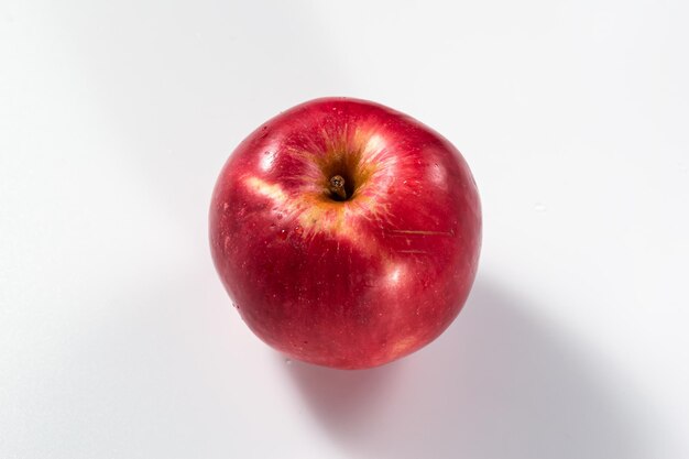 Foto una manzana roja sobre un fondo blanco