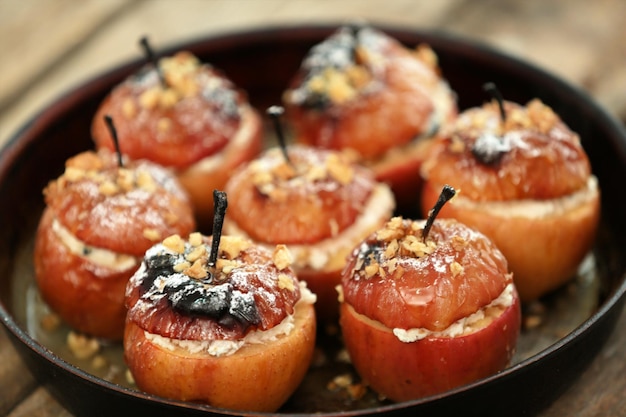 Manzanas al horno con queso cottage, pasas y nuez en una sartén de cerca