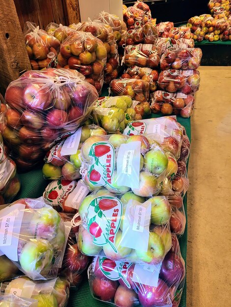 Manzanas frescas en bolsas de plástico en una exhibición de mercado interior