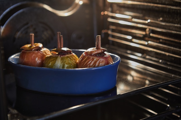 Las manzanas se hornean en el horno con relleno de nueces y canela.