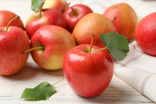 Manzanas y toalla en la mesa de madera blanca