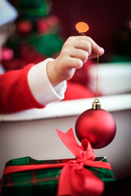 Foto mão cortada de mulher segurando decoração de natal