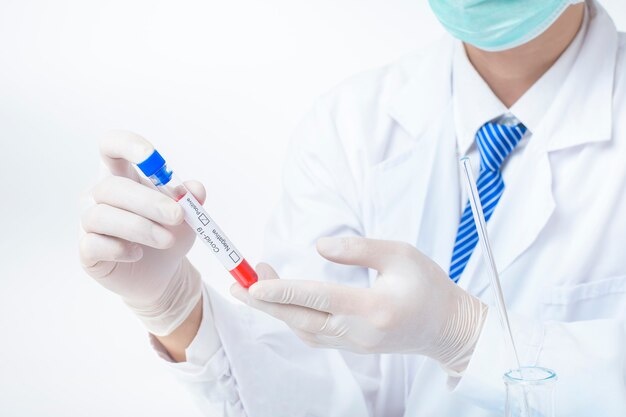 Foto mão de assistente de laboratório está segurando o exame de sangue infectado covid-19