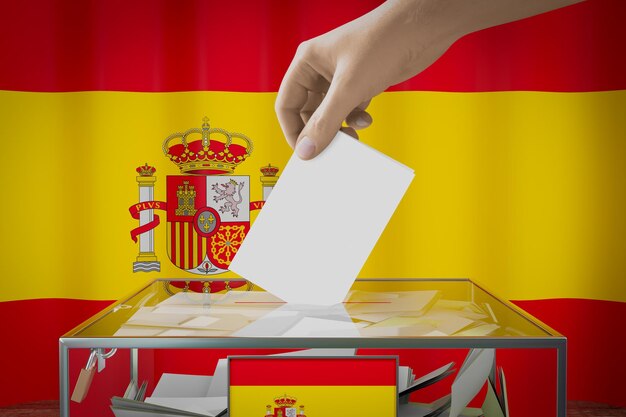 Mão de bandeira da Espanha deixando cair o cartão de cédula em um conceito de eleição de votação de caixa