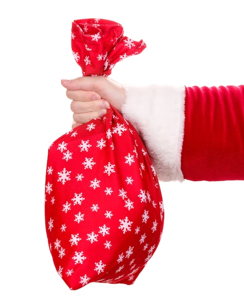 Foto mão de papai noel segurando um saco de presentes isolado no branco