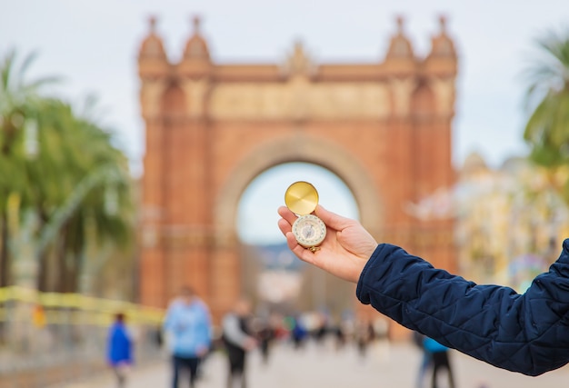 Mão de um homem com uma bússola barcelona arco do triunfo. foco seletivo.