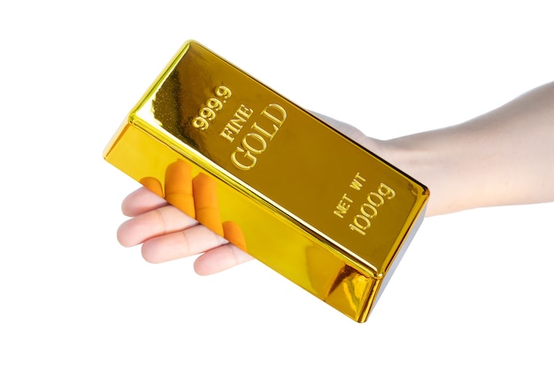 Mão humana segurando uma barra de ouro de 1 kg