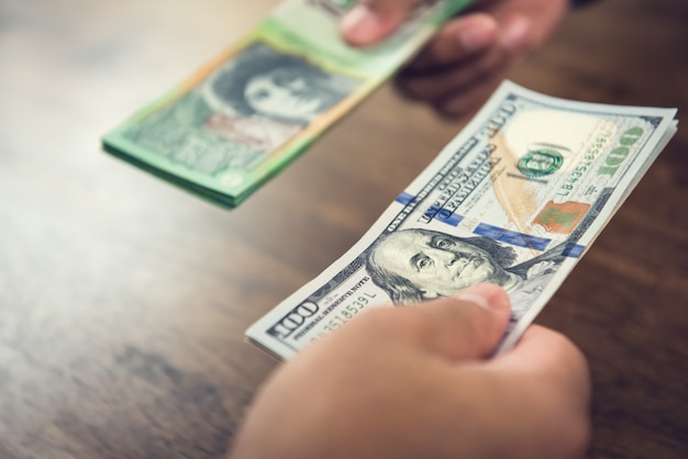 Foto mão segurando as notas de dólar nos negócios com dólares australianos