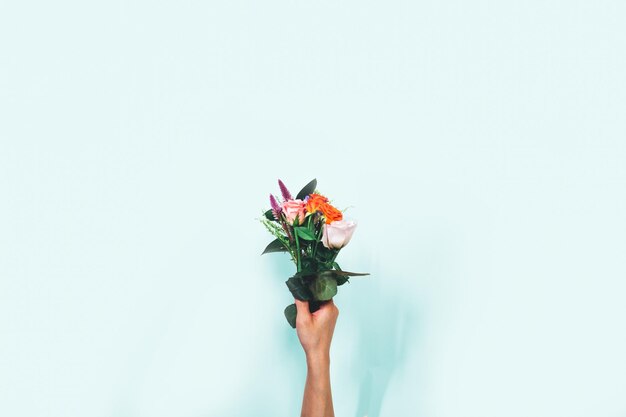 Foto mão segurando flores sobre fundo branco