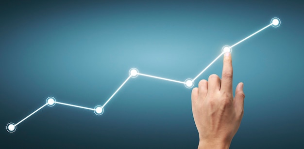 Mão tocando um gráfico de indicador financeiro e gráfico de análise de economia de mercado contábil