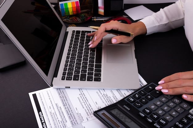 Foto mãos de mulher usando um laptop no escritório