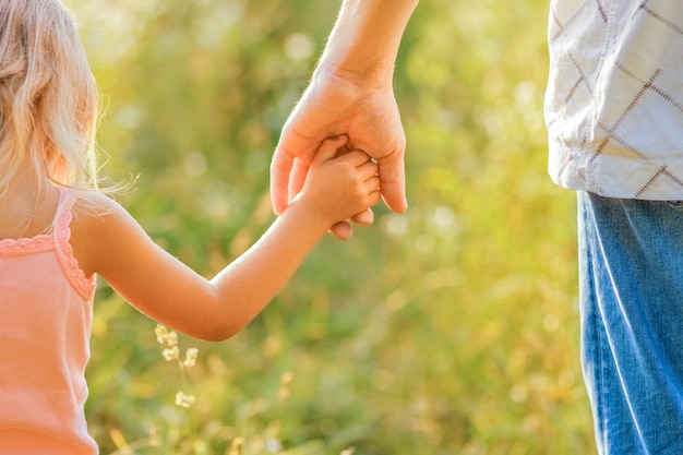 Mãos de pais e filhos ao ar livre no parque