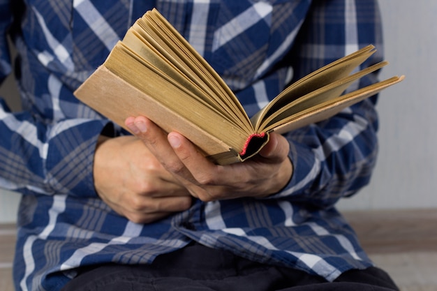 Mãos do homem closeup com livro aberto