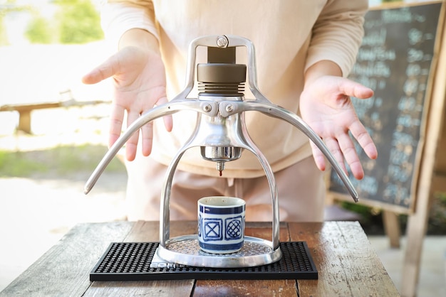 Foto mãos mostrando fazer café expresso quente da máquina no estilo de beber