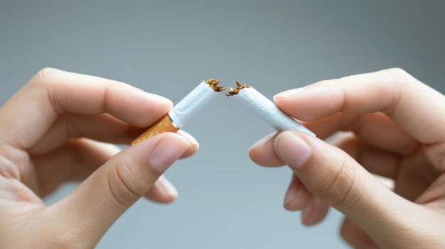 Mãos rasgando um cigarro enfatizando a decisão de parar de fumar e acabar com o vício
