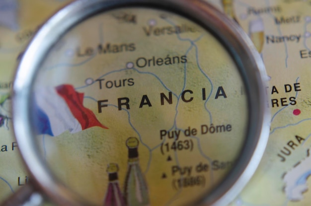 Foto mapa de francia visto con una lupa con su bandera