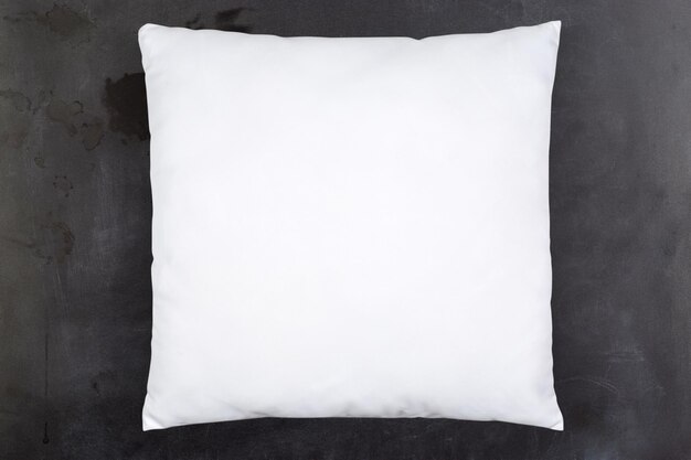 Maqueta de almohada blanca sobre fondo de pizarra retro
