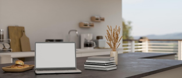 Maqueta de computadora portátil en islas de cocina negras modernas o encimera de cocina en cocina casera moderna