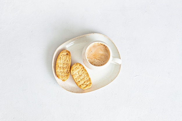 Maqueta de escritorio mínima con estilo con taza de café y galletas