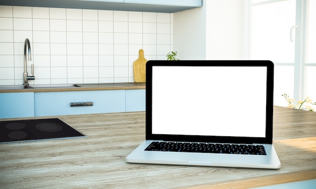 Maqueta de portátil de pantalla blanca en la isla de cocina en cocina
