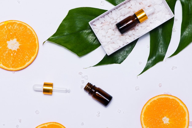 Maquete de branding. Óleo essencial natural, frascos de cosméticos com rodelas de laranja.