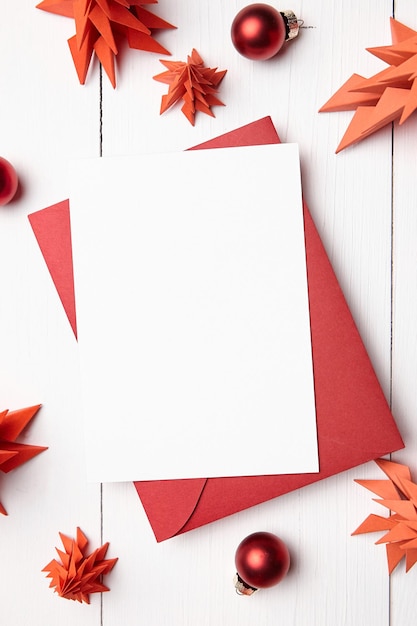 Maquete de cartão de Natal com envelope e abetos de papel vermelho